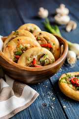 Baked small mushroom pies with cheese and pepper