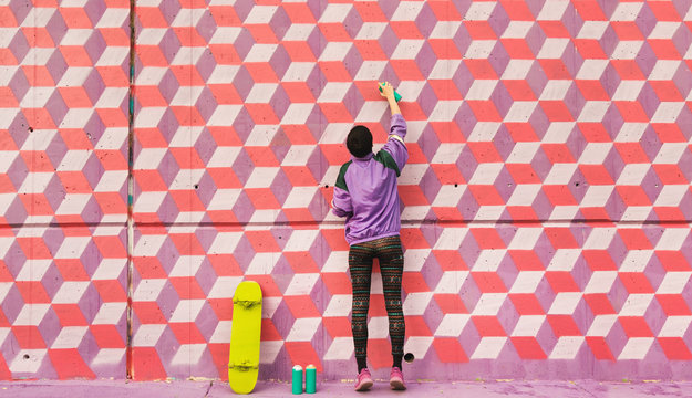 Young girl writing graffiti
