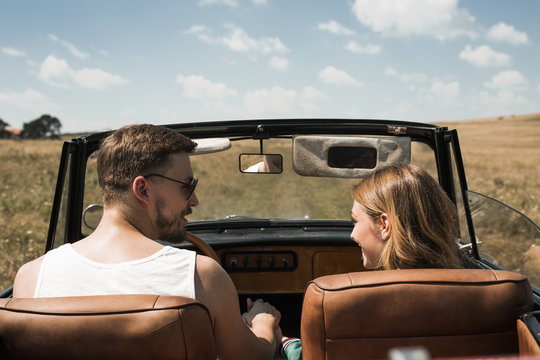 Couple in Love Driving in Convertible Car