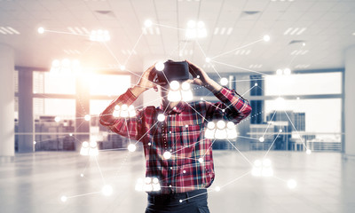 Guy wearing checked shirt and virtual mask demonstrating some em