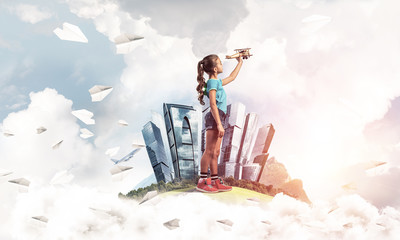 Concept of careless happy childhood with girl dreaming to become