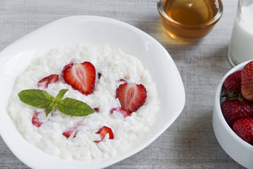 Dairy rice porridge with strawberries in a plate