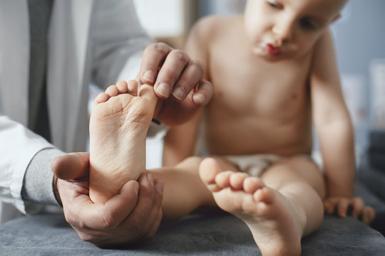 Doctor Examining Boy's Feet