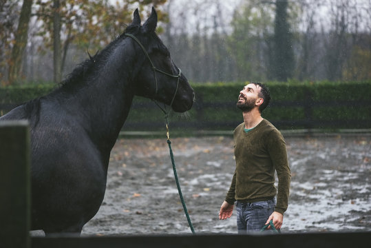 Man and horse enjoying the rain
