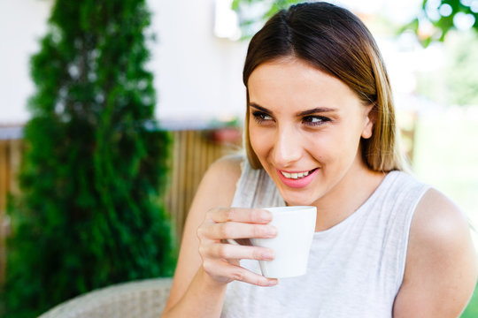 Beautiful girl smiling and drinking coffe