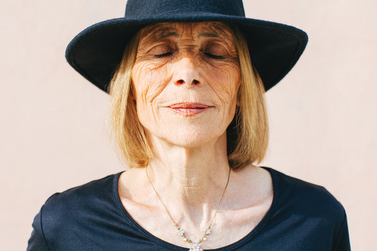 Close up portrait of a mature woman with eyes closed outside 