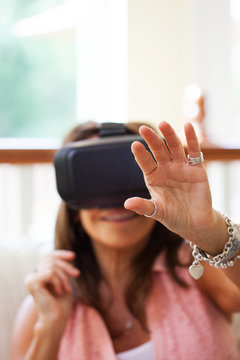 VR Mature Woman Reaches Out While Wearing Virtual Reality Headset