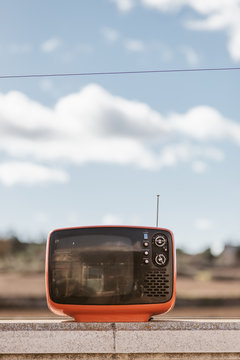 Vintage television with a sky background
