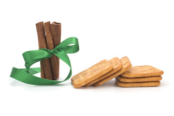 Cinnamon sticks, salted biscuits on white background