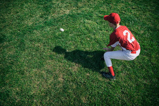 Outfielder catching baseball on field