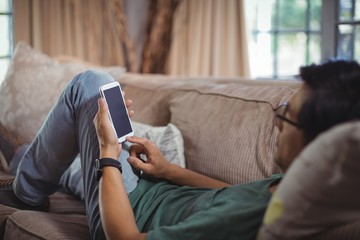 Man using mobile phone in living room