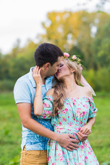 happy young couple kissing and hugging on nature