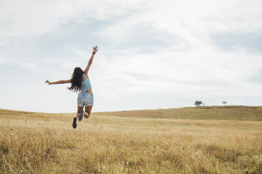 Young Woman Jumping Outdoors
