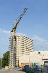 Fototapeta premium The high crane behind the future with a scaffold.