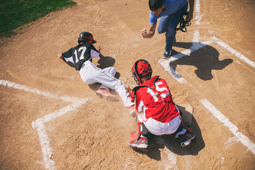 Baseball umpire calls runner out at home plate