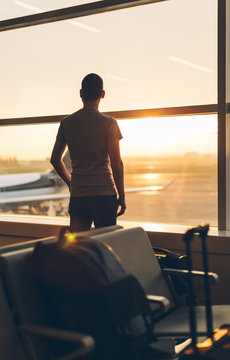 Man Waiting for an Airplane at the Airport Gate