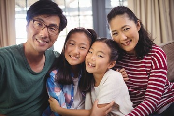 Smiling family relaxing on sofa in living room