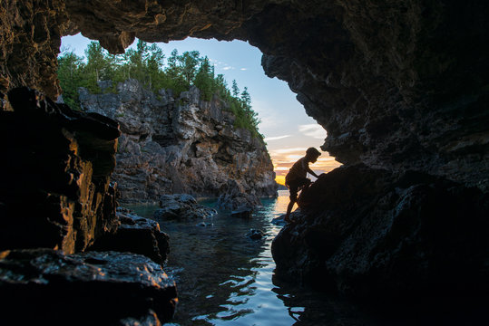 Adventerous Boy Exploring Grotto Sea Cave on Georgian Bay Bruce Peninsula National Park Tobermory