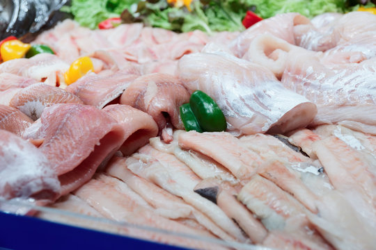 Fish fillets on ice in fishmonger shop