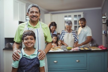 Grandfather and grandson smiling at camera 