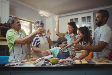 Happy family preparing dessert in kitchen