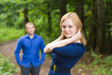 portrait beautiful young couple man woman quarreled background summer green park.