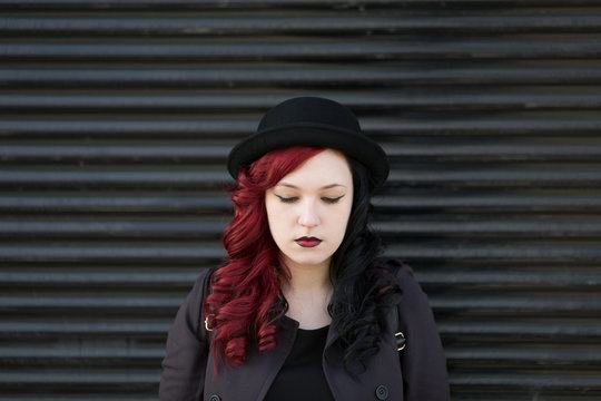 Portrait of a real young woman  with red and black hair 