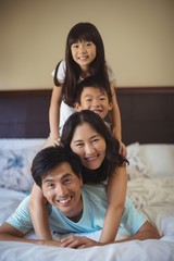 Fototapeta premium Happy family having fun on bed in the bed room