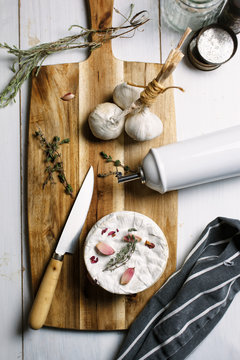Ingredients for baked camembert cheese on a wooden cutting board Seen from above