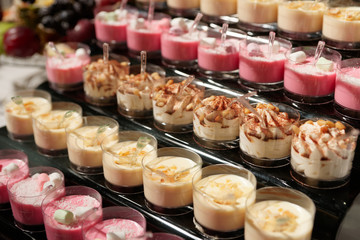 Pink panna cotta and other desserts on restaurant table