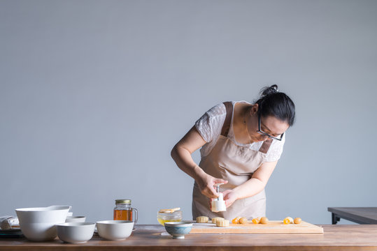 A young woman is making moon cake at home