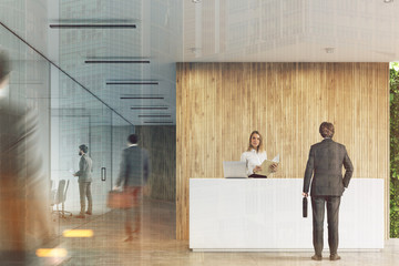 Fototapeta na wymiar White reception, wooden office, people toned