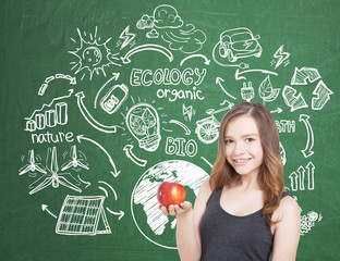 Smiling teen girl with apple, ecology