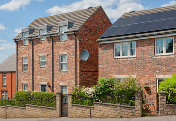 Brick houses with solar systems in the UK.