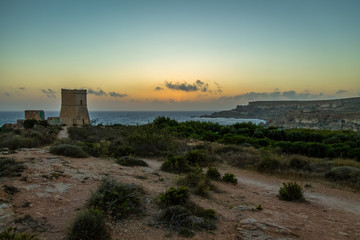 Ghajn Tuffieha Tower in Golden Bay at sunset - Malta