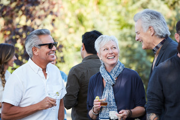 Group of friends enjoying cocktails at an outdoor party