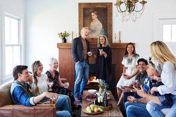 Group of friends and family having a cocktail party in their home