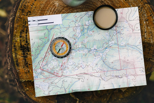Map a compass and a coffee