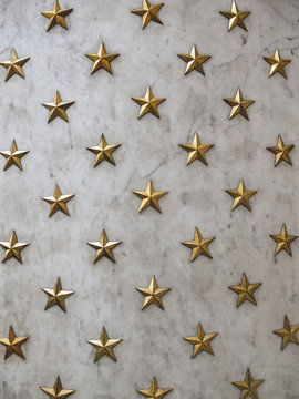 Gold stars background on marble wall