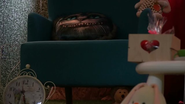 Armchair with a pillow in the form of a Cheshire cat at a children's party