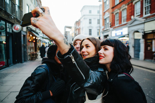 A group of beautiful young women take a selfie