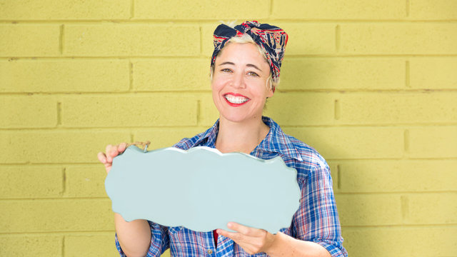 Waist up portrait, super happy excited successful hipster business woman holding blank sign for copy, ---Isolated on painted green brick wall. Positive emotion from the benefits of financial reward.