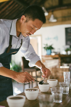 Young man making experiment on coffee and comparing