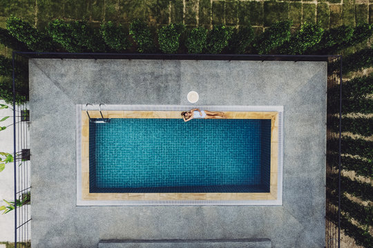 Woman Relaxing by a Swimming Pool