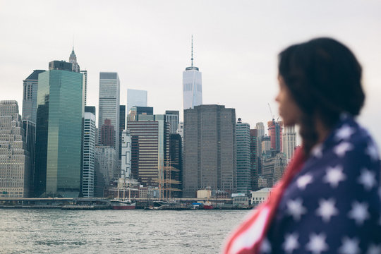 Woman looking Manhattan covering with an American Flag