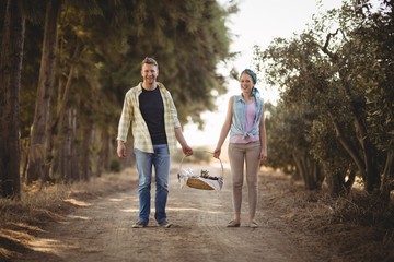 Fototapeta premium Portrait of couple carrying basket while walking