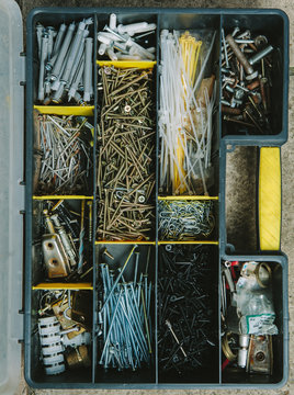 Toolbox containing various screws bolts and drill bits