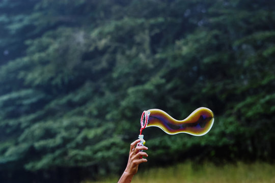 Woman Making Bubbles for Children