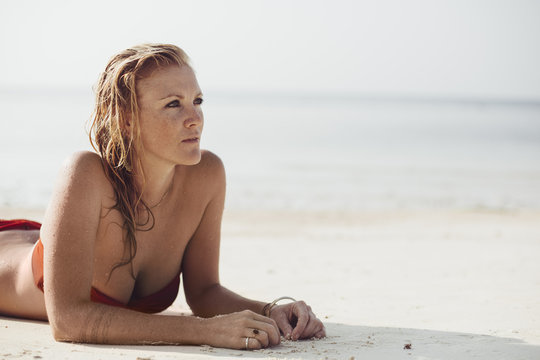 Blonde Woman Sunbathing at the Beach