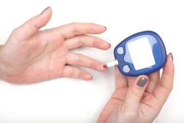 Close-up Of Woman Hands Testing High Blood Sugar With Glucometer